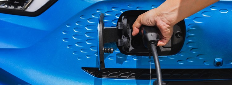 Vue d'une voiture hybride rechargeable dans un environnement urbain, idéale pour les trajets en zone urbaine.